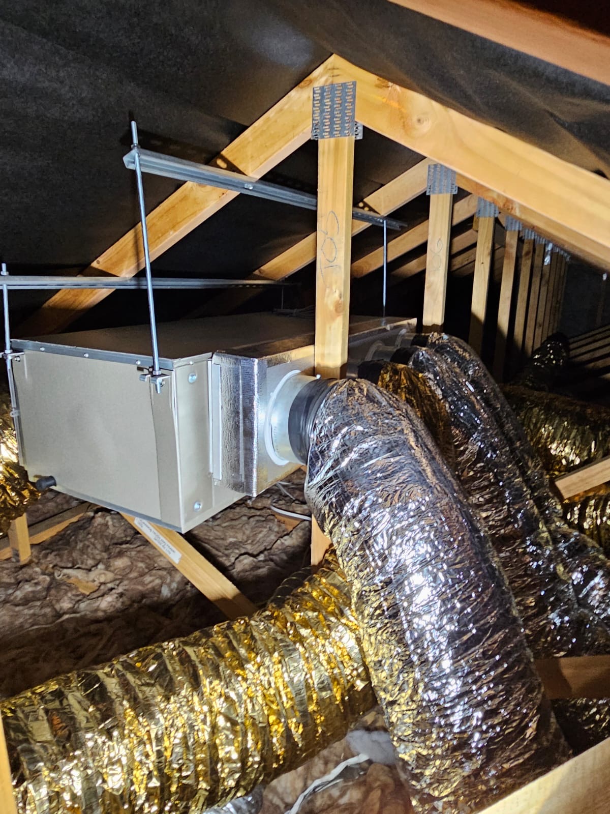 Ducted heat pump ceiling unit mounted in roof space of Tauranga home